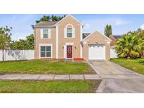 Charming two-story home with a well-manicured lawn and a one-car garage at 12110 75Th St, Largo, FL 33773