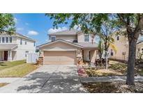 Charming two-story home with a two-car garage, landscaped yard, and inviting entryway in a well-maintained neighborhood at 13511 Fladgate Mark Dr, Riverview, FL 33579