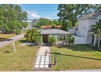 Charming home featuring a walkway with interspersed stone squares and lovely landscaping at 3131 W Fielder St, Tampa, FL 33611