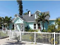 Charming coastal home with a picket fence and lush tropical landscaping at 5201 18Th S Ave, Gulfport, FL 33707