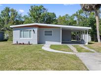 Charming single-story home featuring a covered carport, freshly painted exterior, and well-maintained lawn at 7139 Adare Dr, New Port Richey, FL 34653
