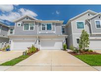 Charming townhomes feature attached garages, gray siding, and well-maintained landscaping for curb appeal at 17212 Balance Cv, Land O Lakes, FL 34638
