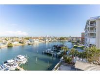 Gorgeous waterfront view featuring docks and boats under a clear blue sky at 223 Island Way # 5E, Clearwater Beach, FL 33767