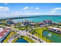 Stunning aerial view of waterfront condo community with lush landscaping and beautiful water views at 6357 Bahia Del Mar Blvd # 403, St Petersburg, FL 33715