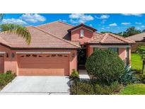 Charming single-story home featuring a tile roof, two-car garage, and well-maintained landscaping at 146 Shell Falls Dr, Apollo Beach, FL 33572