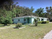 Charming single-story home with a well-maintained lawn and mature trees in a desirable neighborhood at 2001 E Powhatan Ave, Tampa, FL 33610