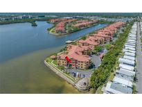 Stunning waterfront condominium complex featuring lush landscaping and serene water views at 2773 Via Cipriani # 1322A, Clearwater, FL 33764