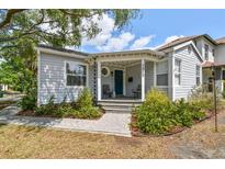 Charming home with a covered porch, quaint landscaping, and a welcoming entrance at 2815 W Estrella St, Tampa, FL 33629