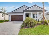 Charming single-story home with a two-car garage, manicured lawn, and beautiful landscaping at 31764 Griffin Sands Ln, San Antonio, FL 33576