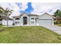 Charming single-story home with a well-manicured lawn and inviting curb appeal at 5189 Brackenwood Dr, Spring Hill, FL 34609