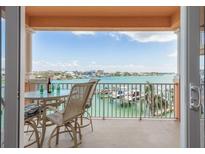 Relax on the balcony with stunning water views and enjoy the outdoor seating arrangement overlooking the marina at 530 S Gulfview Blvd # 303, Clearwater, FL 33767