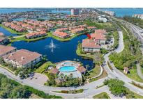 Stunning aerial view of a waterfront community with a pool, fountain, and beautifully landscaped grounds at 6 Academy S Way # 23A, St Petersburg, FL 33711
