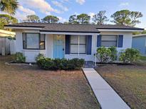 Charming single-story home with a well-maintained front yard and a bright blue front door at 754 71St N Ave, St Petersburg, FL 33702
