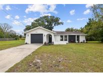 Charming single-story home boasts a modern exterior with a well-maintained front yard at 8512 Longboat Ln, Hudson, FL 34667