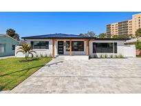 Charming home featuring modern upgrades, a new roof, and a spacious paver driveway at 864 Mandalay Ave, Clearwater Beach, FL 33767