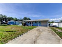 Charming single-story home with a long driveway and well-maintained front yard at 11487 80Th Ave, Seminole, FL 33772
