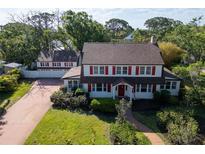 Charming two-story home features a landscaped yard and a separate garage at 1226 Serpentine S Dr, St Petersburg, FL 33705