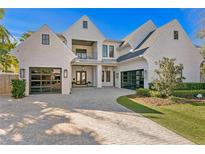 Beautiful two-story home featuring brick, two-car garages, and a manicured lawn with a paved driveway at 1903 S Cardenas Ave, Tampa, FL 33629
