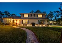 Charming two-story home with manicured lawn, stone accents, and inviting pathway at 14344 83Rd Pl, Seminole, FL 33776