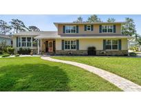 Charming two-story home with a beautifully landscaped front yard and unique brick walkway at 14344 83Rd Pl, Seminole, FL 33776