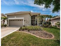 Charming single-story home showcasing manicured landscaping and a two-car garage at 1522 Riverdale Dr, Oldsmar, FL 34677