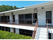 Charming two-story brick building with decorative railings and well-maintained landscaping at 2348 Shelley St # 12, Clearwater, FL 33765