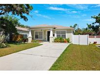 Charming single-story home features a well-manicured lawn and a concrete driveway at 2410 26Th S St, St Petersburg, FL 33712