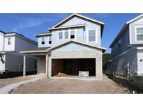 New construction featuring a two-story home with an attached garage, ready for customization and landscaping at 3319 Guanabana Xing, Wesley Chapel, FL 33543