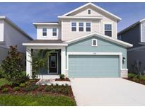 Charming two-story home featuring a two-car garage and beautifully landscaped front yard at 3319 Guanabana Xing, Wesley Chapel, FL 33543