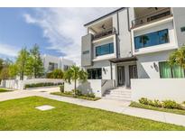 Modern two-story home featuring a manicured lawn and sleek architectural design at 4515 W North A St # 8, Tampa, FL 33609