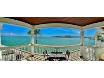 Balcony with table and seating with views of the ocean at 5285 Coquina Key Se Dr # C, St Petersburg, FL 33705