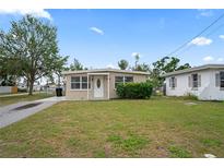 Charming single-story home featuring a well-maintained front yard and a classic architectural design at 5300 6Th S Ave, St Petersburg, FL 33707