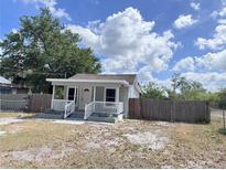 Charming single-story home featuring a welcoming front porch and fenced yard at 804 Whitehurst Rd, Plant City, FL 33563