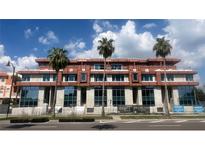Exterior view of new construction building featuring brick, large windows and some palm trees at 85 Davis Blvd # D, Tampa, FL 33606