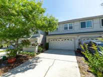Charming townhome featuring a two-car garage and a well-maintained lawn at 2983 Covewood Pl, Clearwater, FL 33761