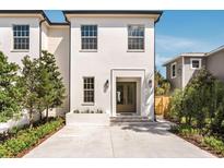 Charming white two-story home with a well-manicured lawn and inviting entrance at 413 W Park Ave # 1, Tampa, FL 33602