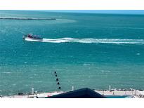Beautiful turquoise water with a boat offshore, visible from the condominium at 450 S Gulfview Blvd # 802, Clearwater Beach, FL 33767