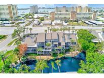Aerial view showing the building near the waterfront, surrounded by palm trees and a scenic pond at 4611 Duhme Rd # 1A, St Petersburg, FL 33708