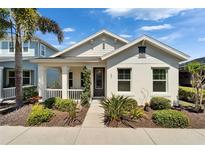 Charming single-story home with a welcoming front porch and well-manicured landscaping at 606 Winterside Dr, Apollo Beach, FL 33572