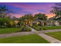 Beautiful single-story home with lush landscaping, lovely walkway, and a charming, inviting curb appeal at 720 Brightwaters Ne Blvd, St Petersburg, FL 33704