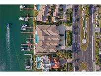 Stunning aerial view of waterfront homes with private docks and a luxurious swimming pool at 830 Pinellas Bayway S, St Petersburg, FL 33715