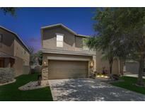 Charming two-story home featuring a two-car garage, landscaped yard, and elegant architectural details at 10524 White Peacock Pl, Riverview, FL 33578