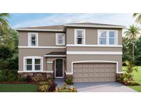 Charming two-story home with stone accents, a two-car garage, and lush landscaping at 10597 Farm Hill Ave, Land O Lakes, FL 34638