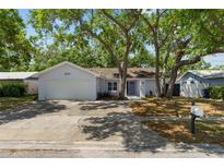 Charming single-story home with a spacious driveway and large trees providing ample shade at 11368 93Rd St, Largo, FL 33773