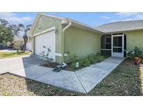 Charming single-story home with a well-manicured lawn and attached two-car garage at 1601 14Th W St, Palmetto, FL 34221