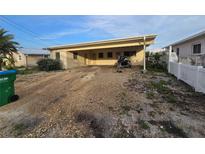 Charming single-story home featuring a covered carport and ample parking space for outdoor activities at 249 144Th Ave, Madeira Beach, FL 33708