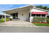Charming single-story home featuring an inviting carport and well-maintained landscaping at 472 Trout Ln, Oldsmar, FL 34677