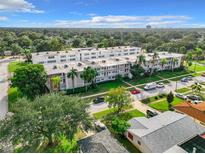 Spacious condo building with well-kept landscaping and mature palm trees at 5150 10Th N Ave # 302, St Petersburg, FL 33710