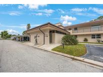 Exterior shot of a cozy condo building with well maintained lawn and street access at 9945 47Th Ave N # 203, St Petersburg, FL 33708