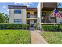 Inviting condo exterior with well-maintained landscaping, multiple units, and visible unit numbers at 2400 Winding Creek Blvd # 2-201, Clearwater, FL 33761